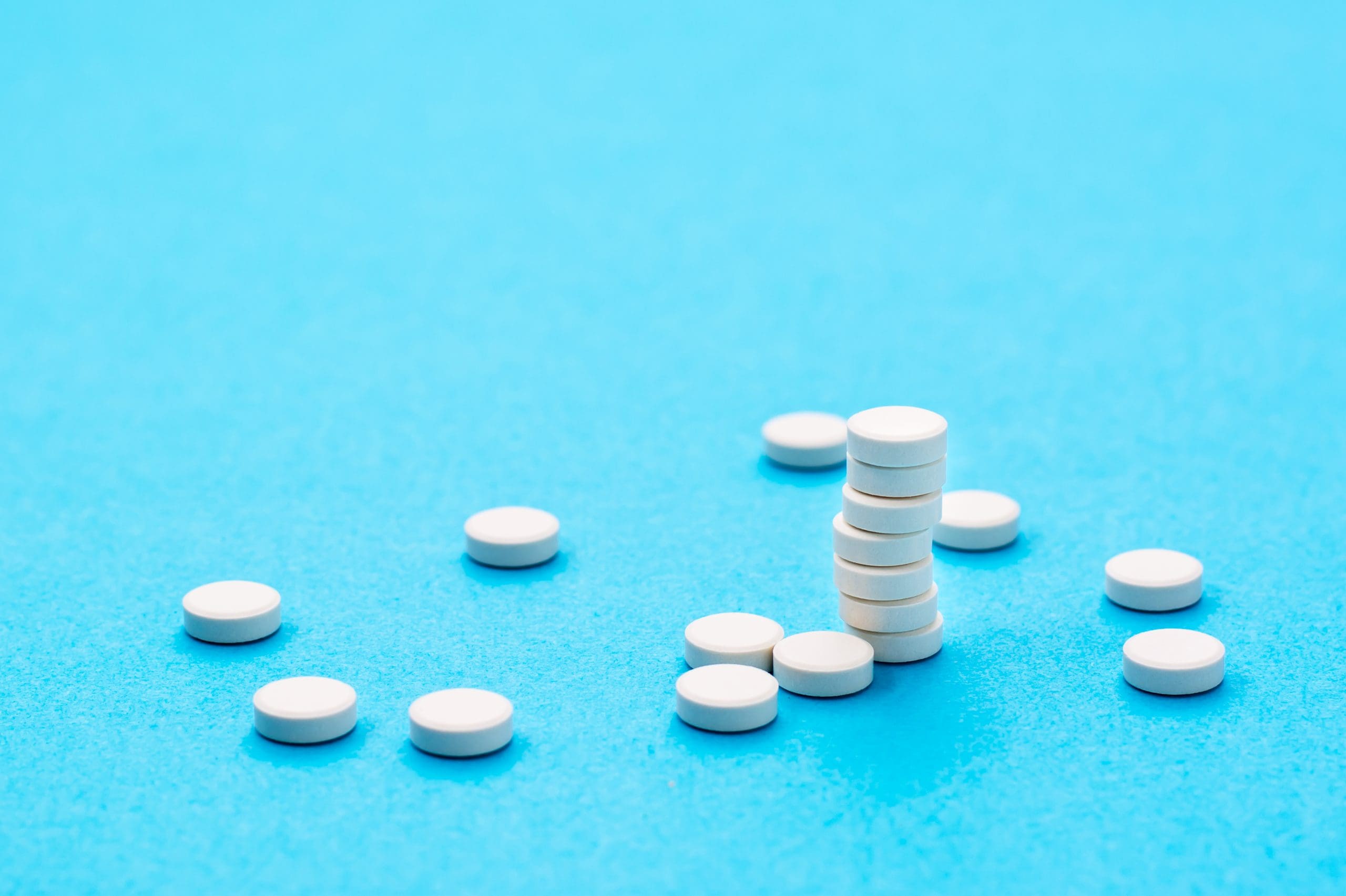 white pills displayed and stacked to show the dangers of tramadol and antidepressants together
