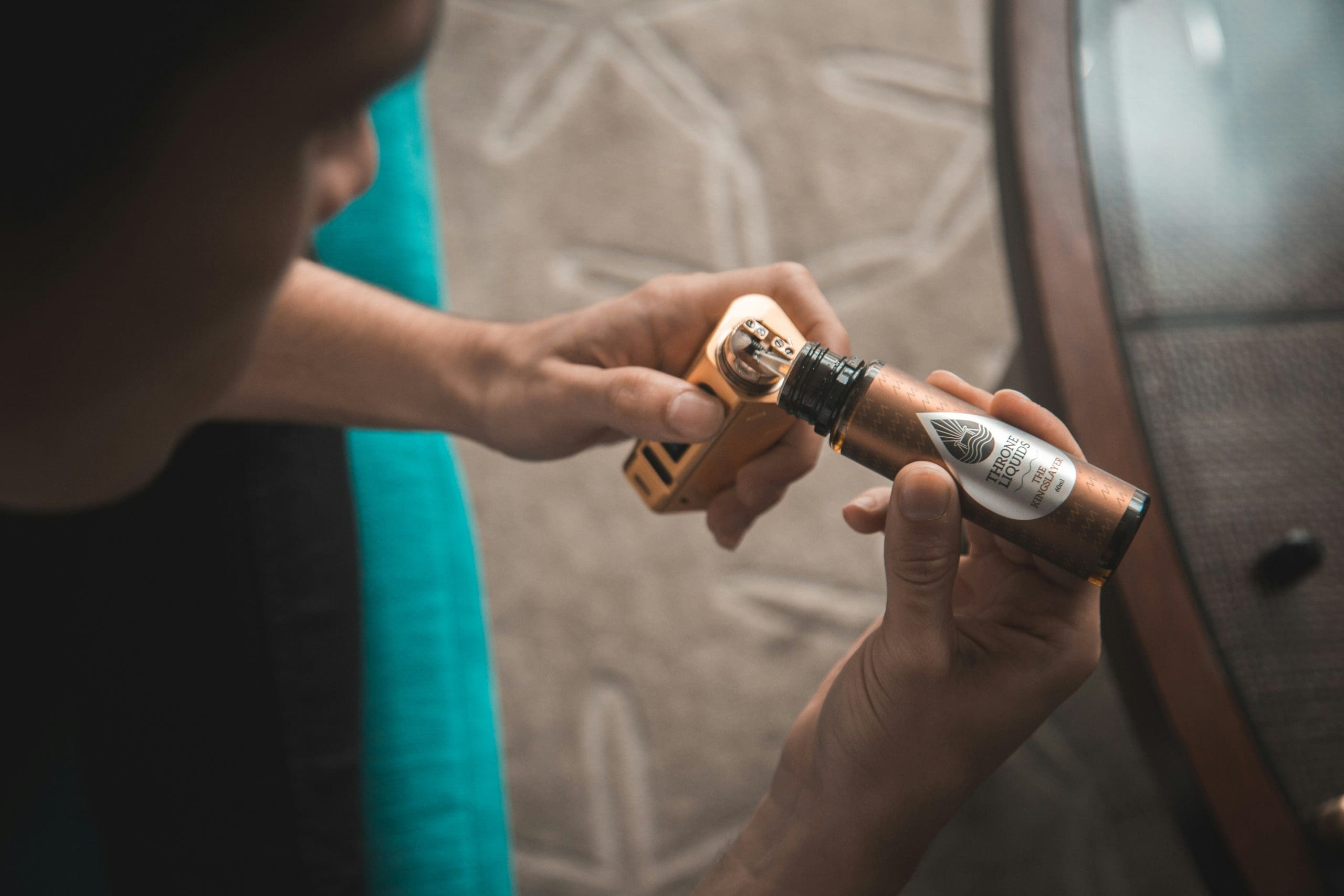 A man filling up a vape. The vape can give the man a type of high that could lead to addiction.