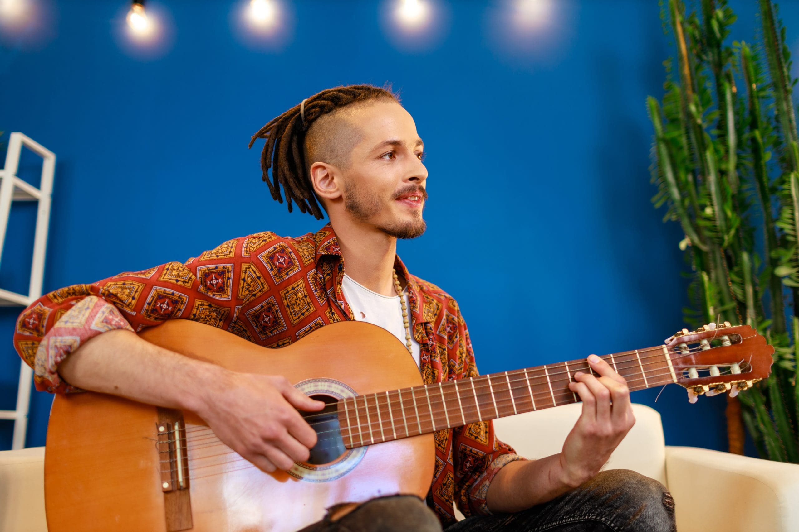 a man playing a guitar during National Hobby Month