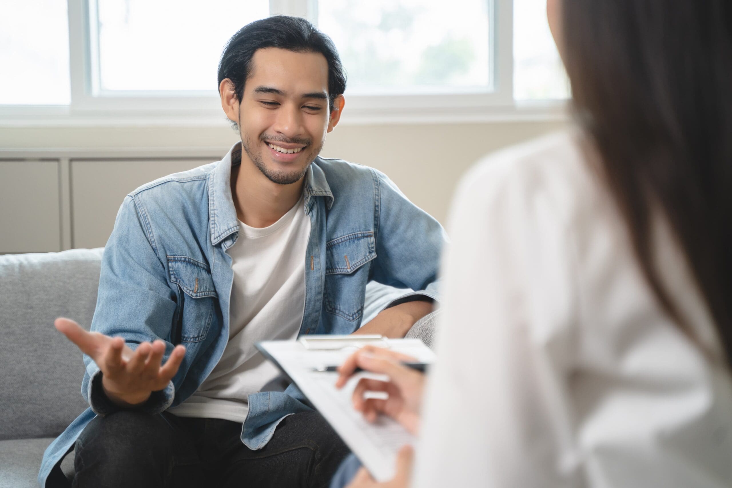 Peer mentor providing one-on-one support in recovery setting