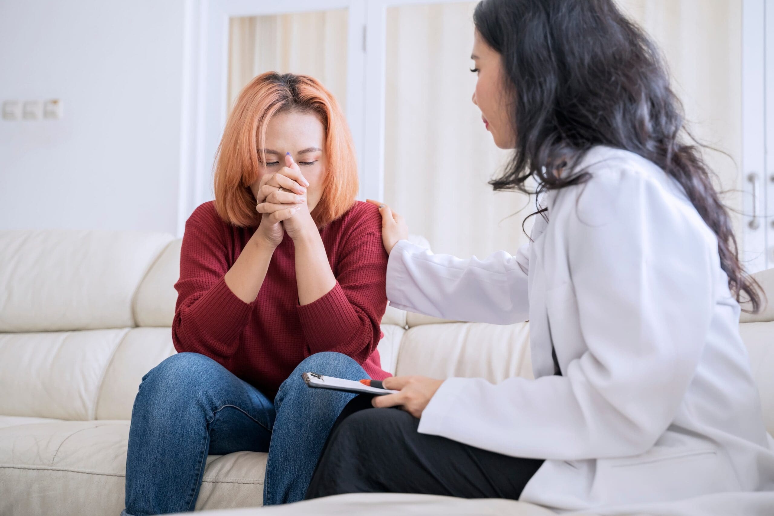 Recovery coach talking with client during supportive coaching session