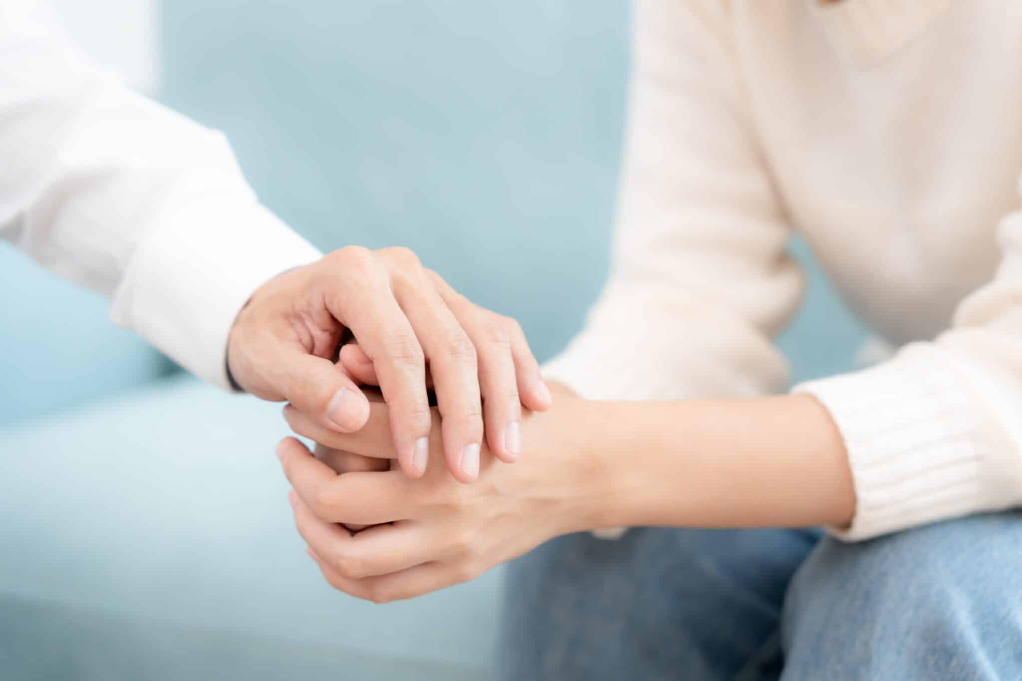 Close-up of two hands meeting in support and connection